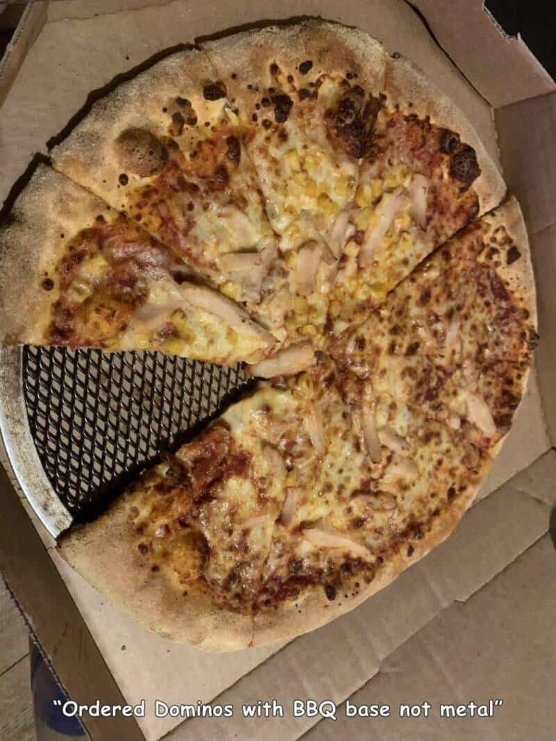 Pizza with BBQ base, not metal, in a box with a pizza cutter.