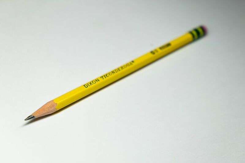 Yellow Dixon Ticonderoga pencil on white background.