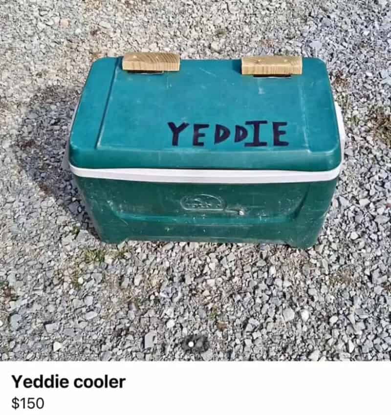 Yeddie cooler with the name written on top, placed on gravel ground.