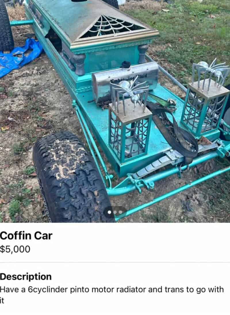 Coffin car with a pinto motor radiator and trans, on a grassy area.