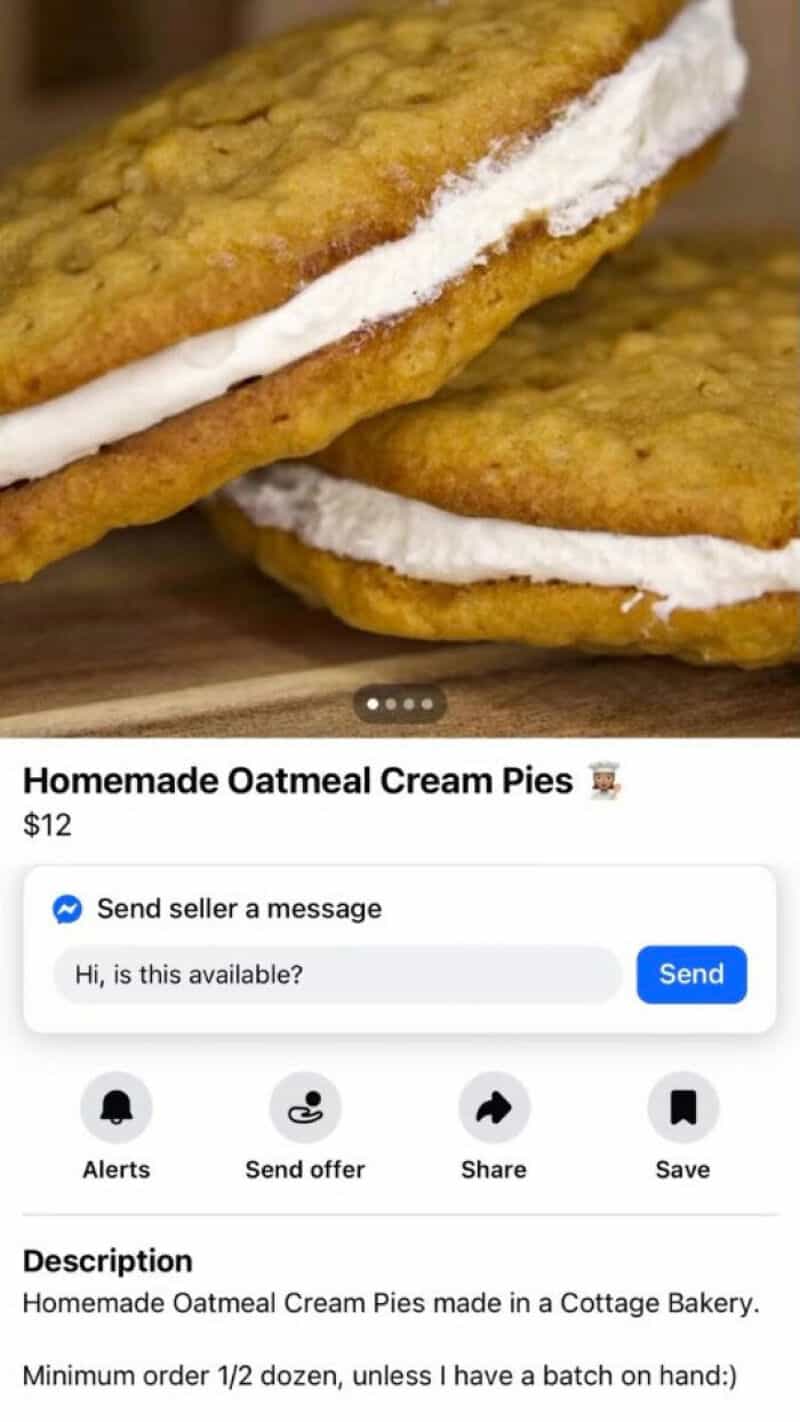 Homemade oatmeal cream pies with white filling on a wooden surface.