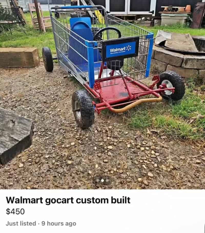 Walmart gocart custom built, red and blue, on uneven outdoor ground with grass and stone.