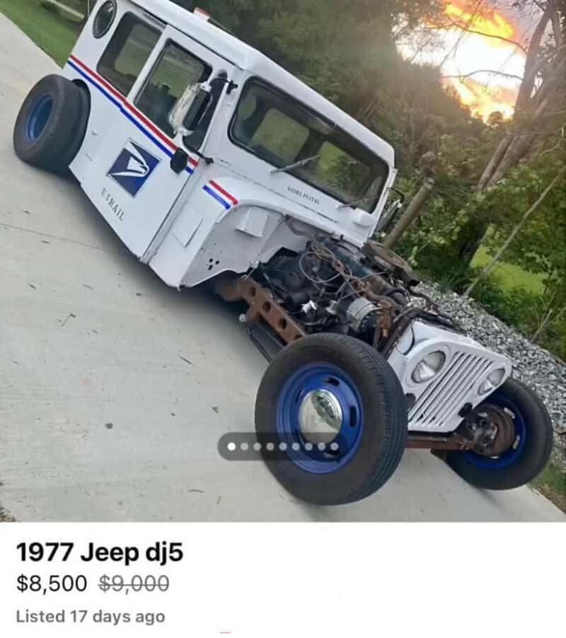 Damaged 1977 Jeep DJ5 USPS postal vehicle with missing front body and exposed engine.