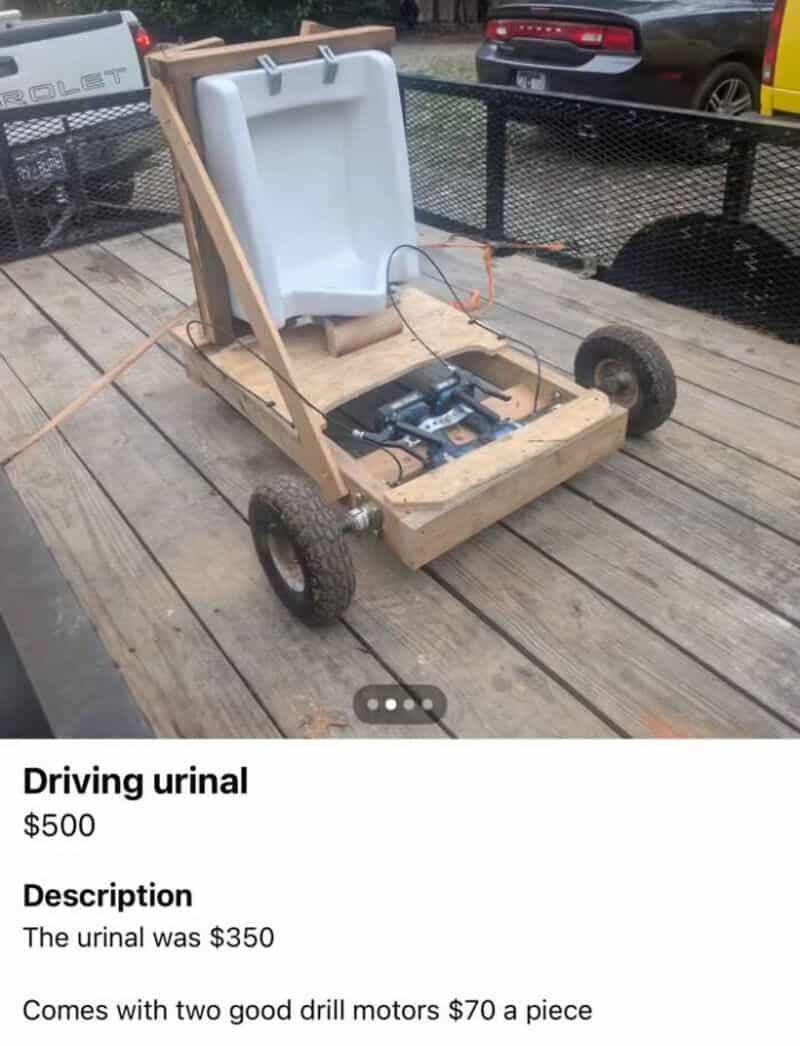 Driving urinal with a white container, wooden frame, and four wheels on a wooden deck.