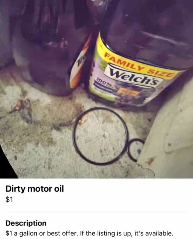 Dirty motor oil container on the ground with a rubber ring and a white object.