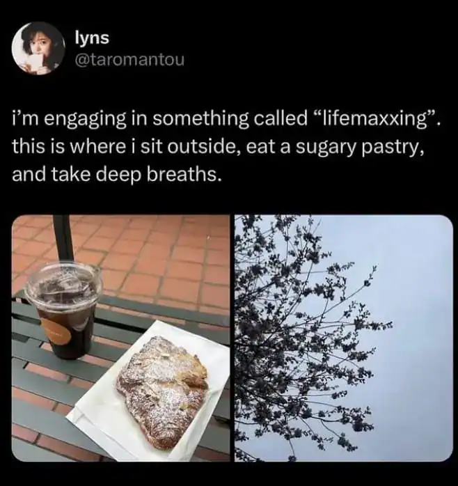 Engaging in "lifemaxxing" with pastry and coffee outside, with a tree and sky in the background.