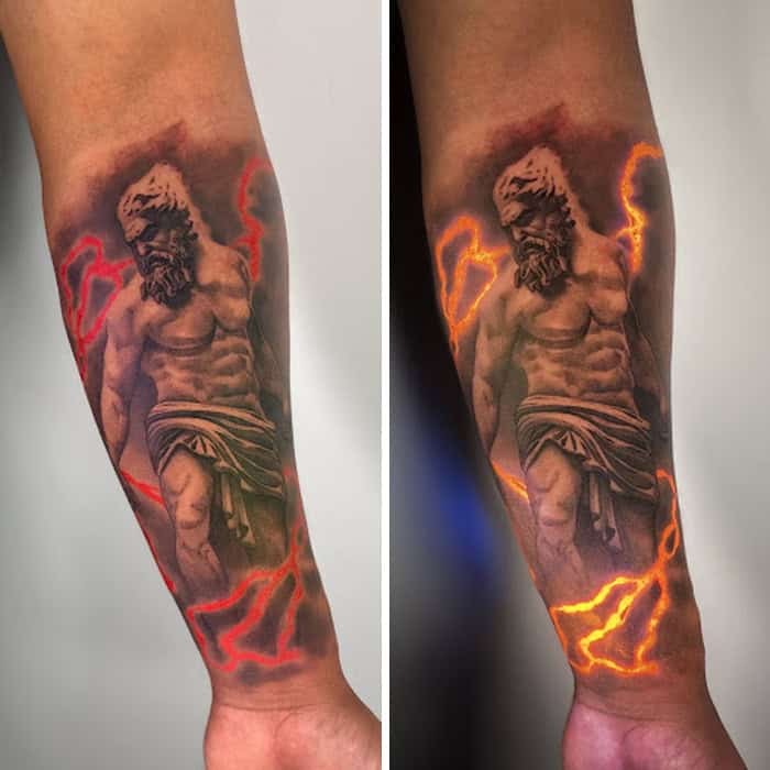 Tattoo of a muscular man with lightning effects in UV ink, visible under UV light.