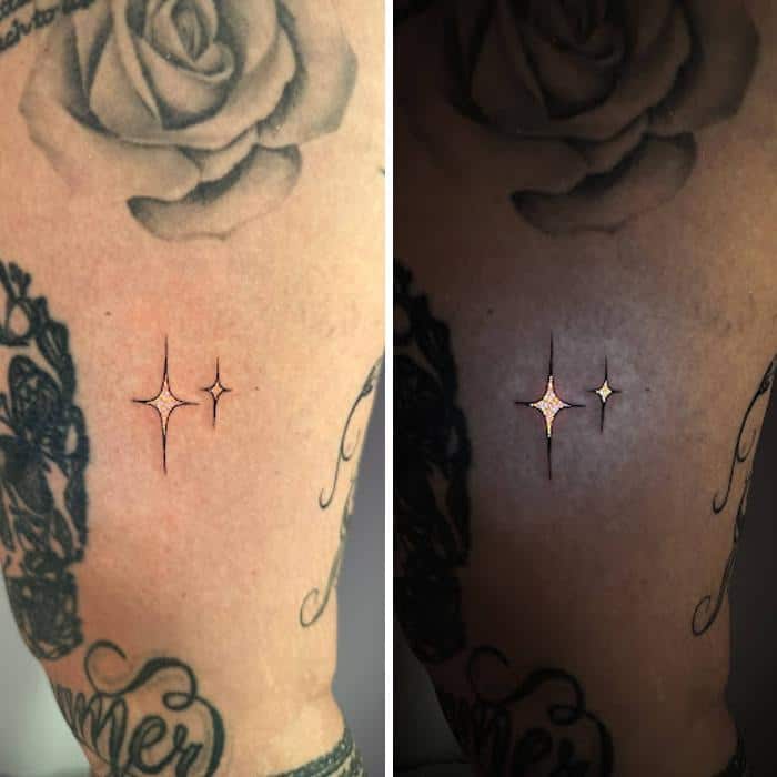Tattoo of two stars on skin, visible under UV light.