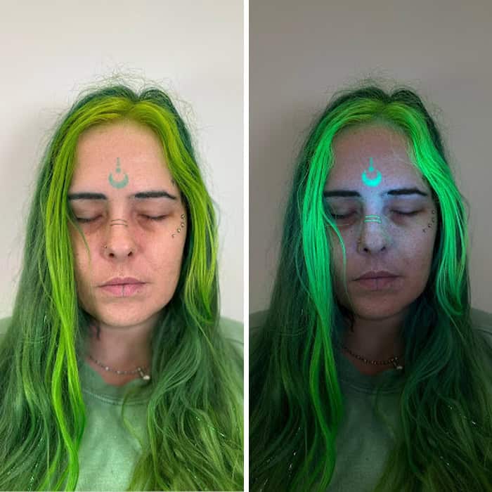 Woman with green hair and UV-reactive ink tattoo under UV light.
