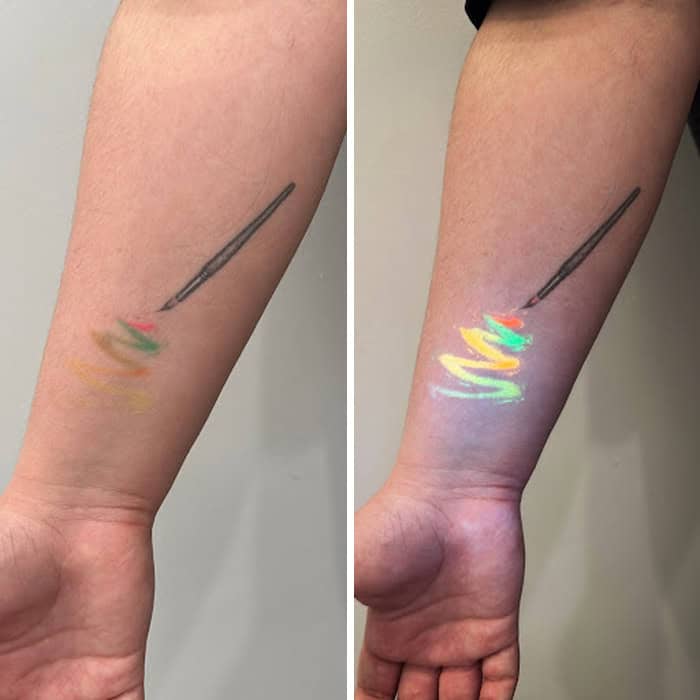 Tattoo of a paintbrush with colorful paint strokes under UV light.