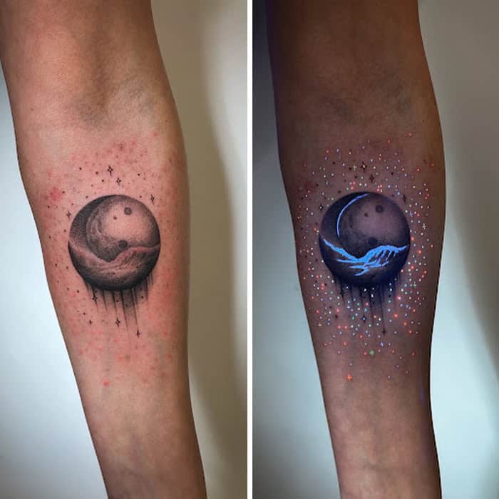 Tattoo of a moon with water and stars, shown under UV light.