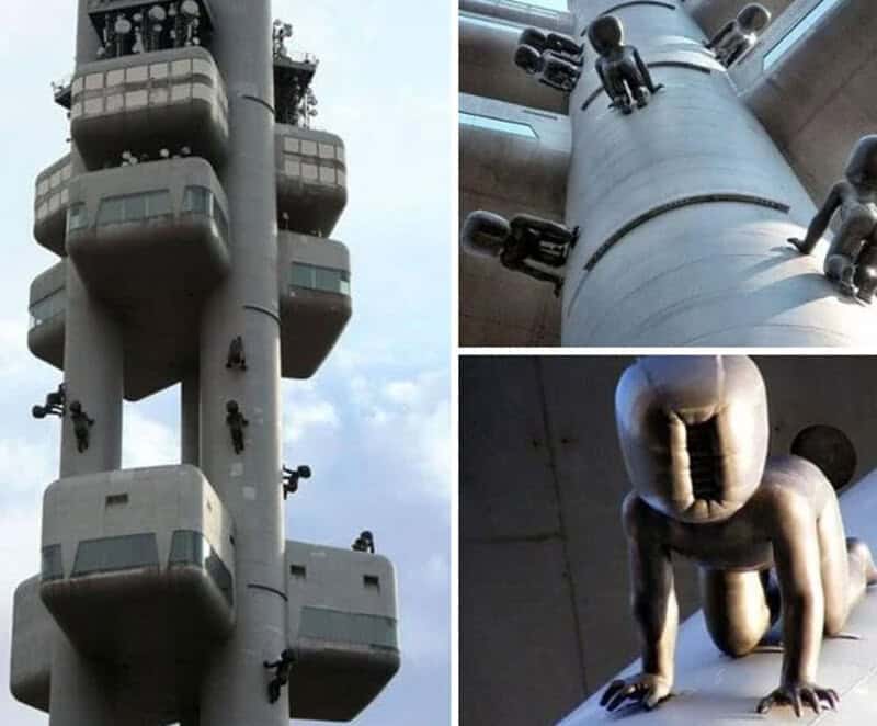 Unique building with balconies and sculptures resembling human figures.