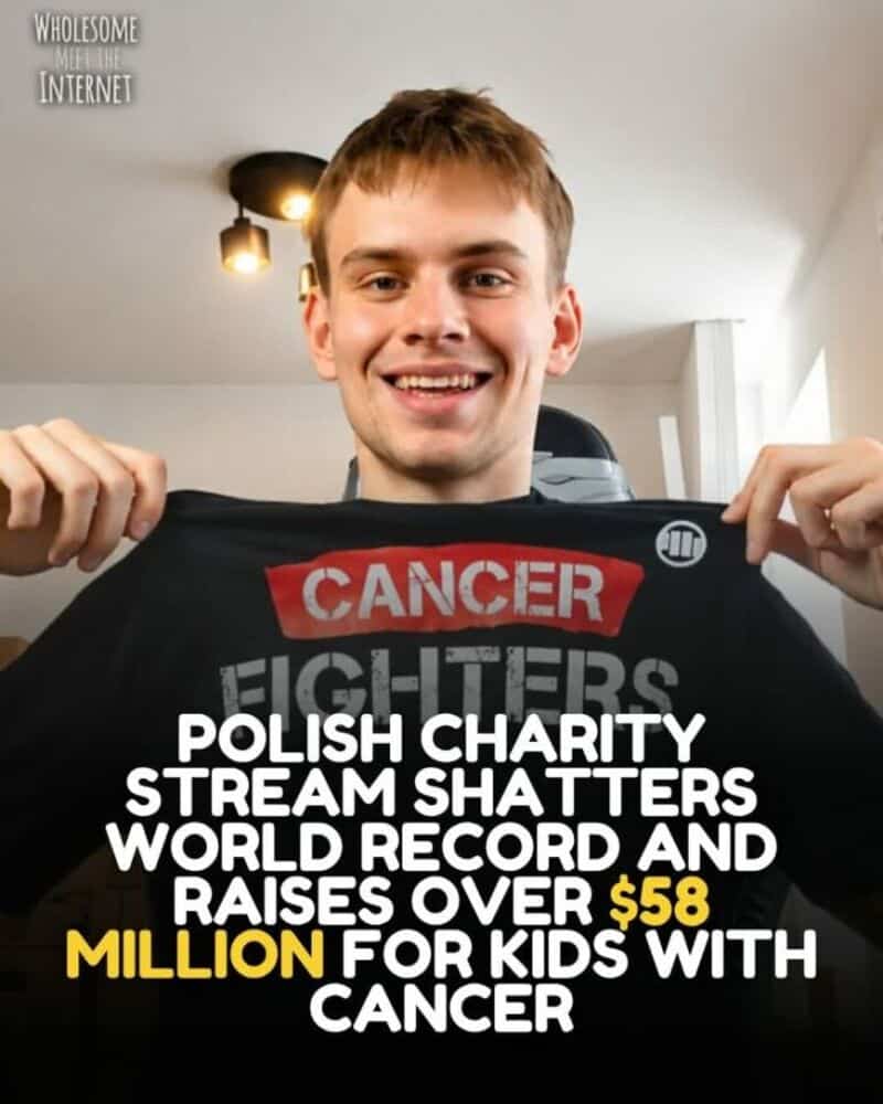 Young man holding a shirt with cancer awareness message, smiling.