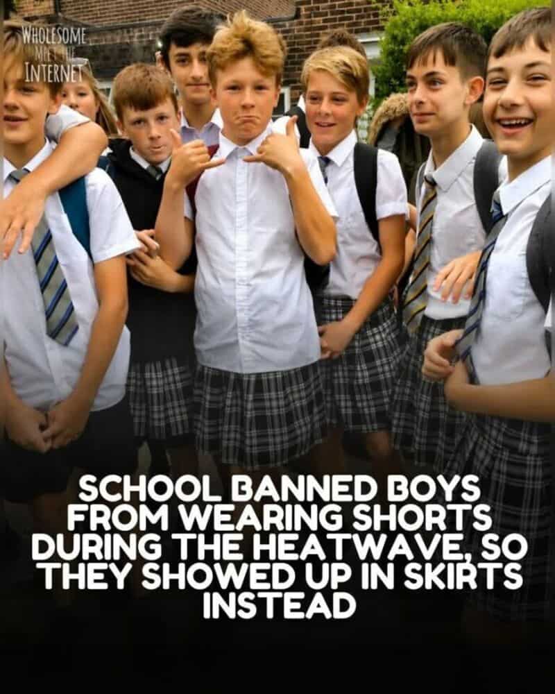 Group of boys in school uniforms, some in skirts, smiling outside.