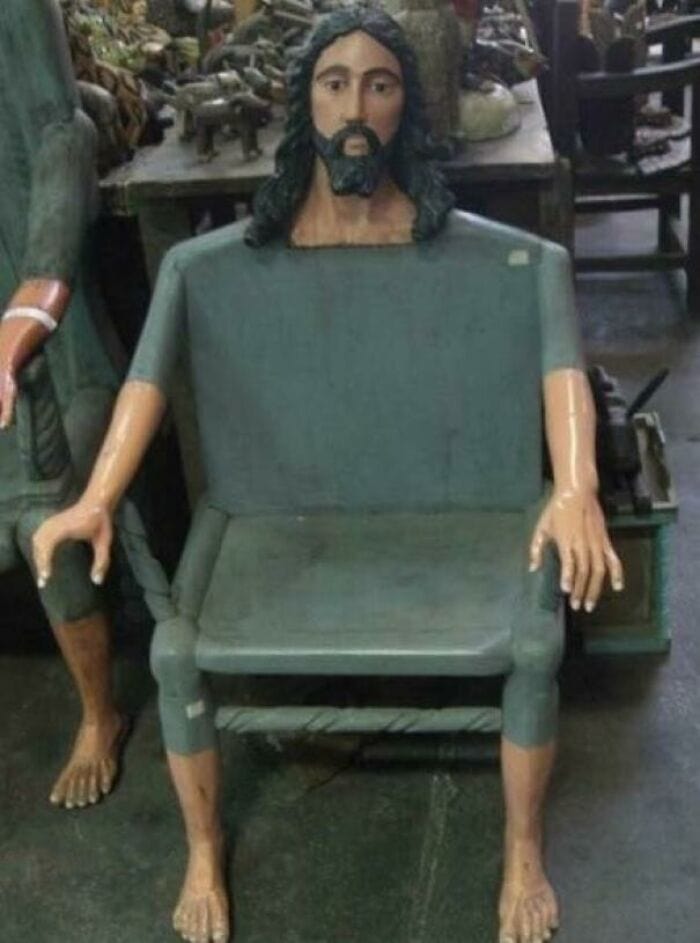 Jesus Christ figure with a bench body and human arms and legs in a store setting.