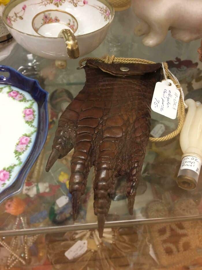 Vintage brown crocodile leather glove with a small pocket and a tag attached.