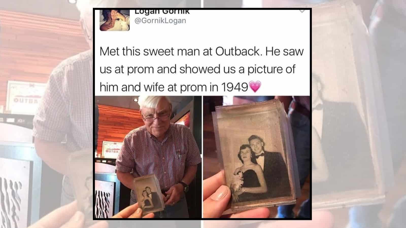 Man holding a framed photo of a woman and a young girl, smiling at Outback.