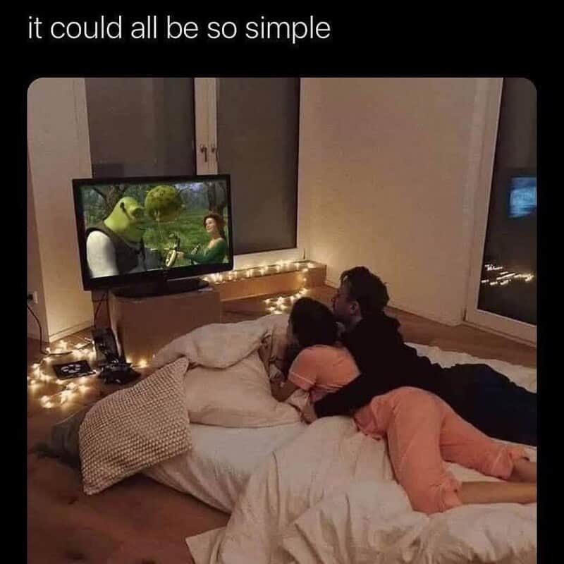 A couple lying on the bed watching TV together, with the caption "it could all be so simple" at the.