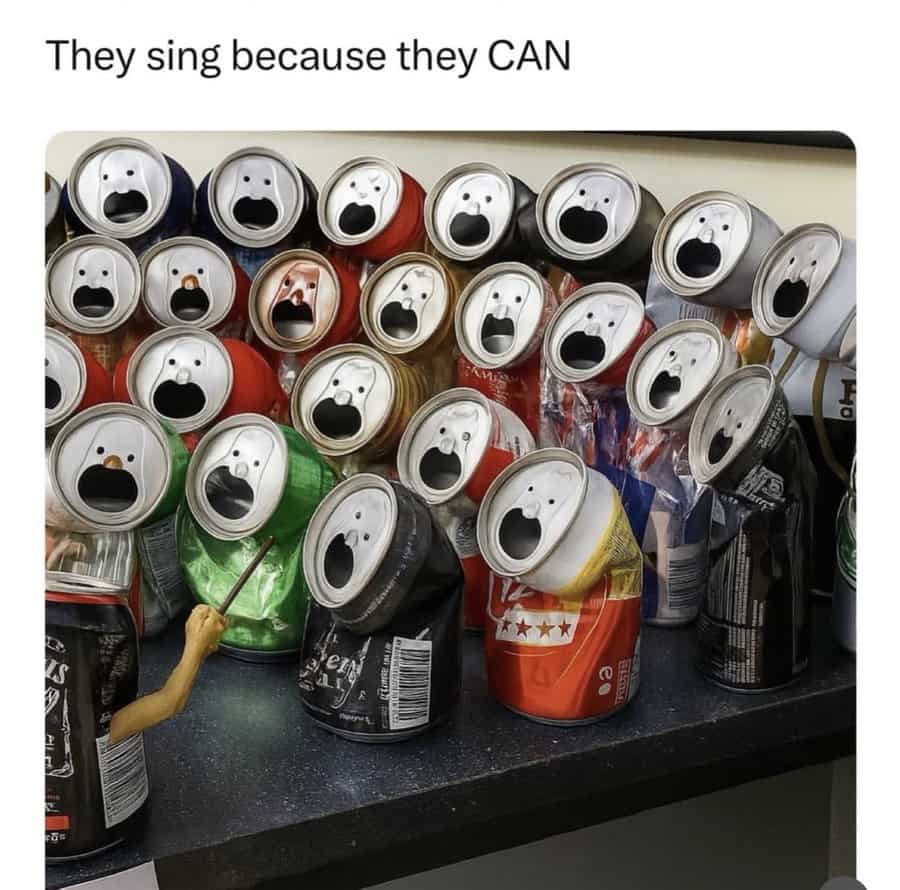 Cans with open tops resembling surprised faces, arranged on a table.
