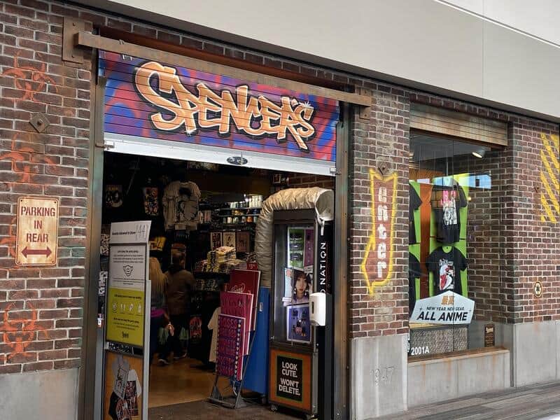 Storefront with graffiti-style sign 'Stance' and anime merchandise inside.