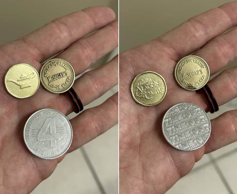 Coins on a hand, including a gold coin, a silver coin, and a smaller gold coin.