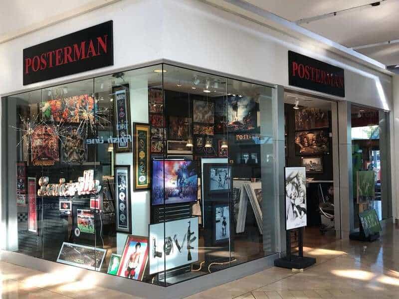 Poster shop with framed artwork and posters displayed inside and outside.