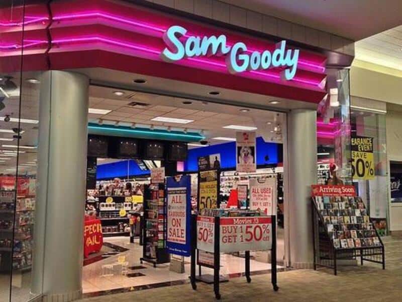 Sam Goody store entrance with sale signs and displays inside.