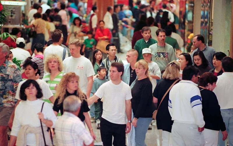 Crowded mall scene with diverse shoppers in the 90s or 2000s.