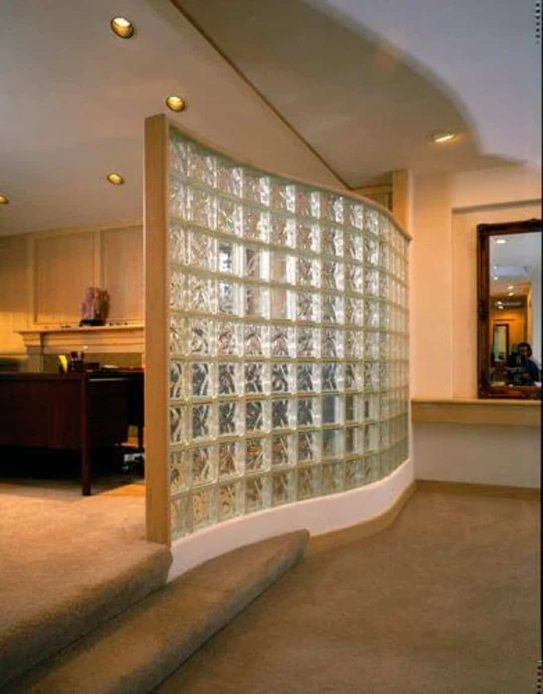 Curved glass block wall in a modern interior space.