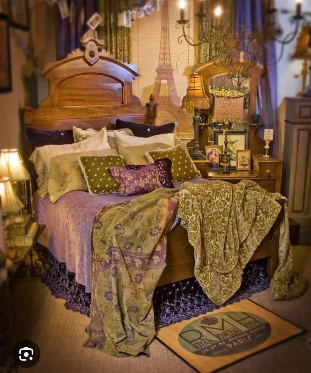 Vintage bedroom with Paris-themed decor, wooden bed, and cozy blankets.