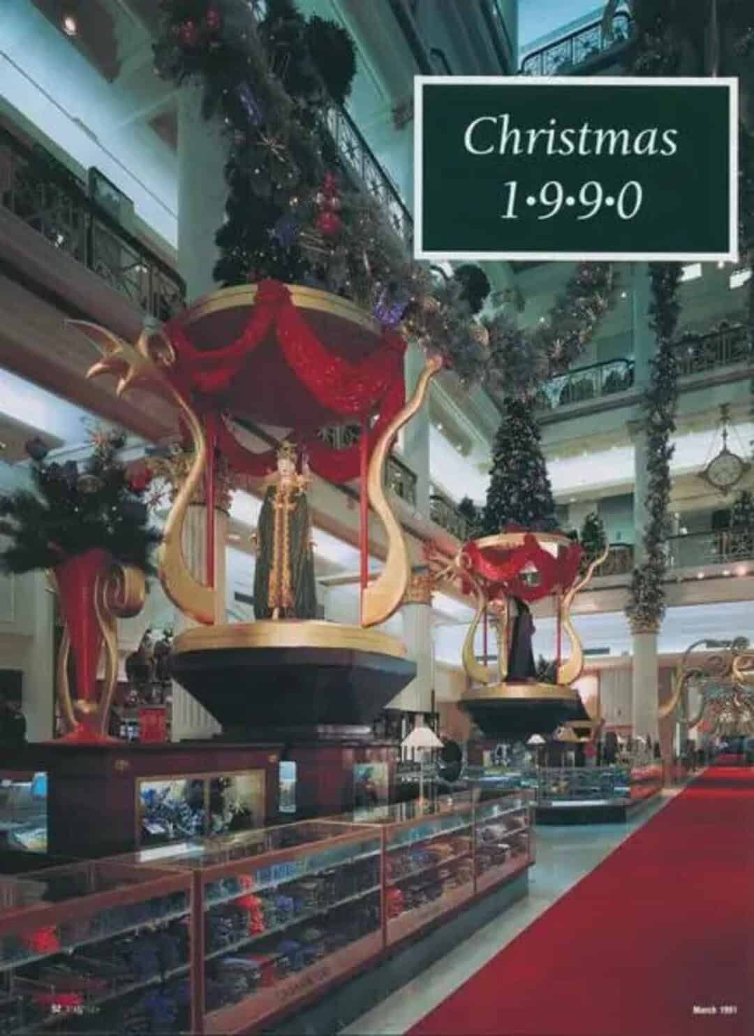 Christmas display with large ornaments and a date 1.9.9.0 in a mall.