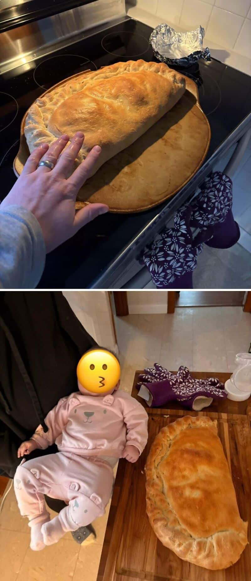 Large baked bread on a round wooden board with a hand nearby.