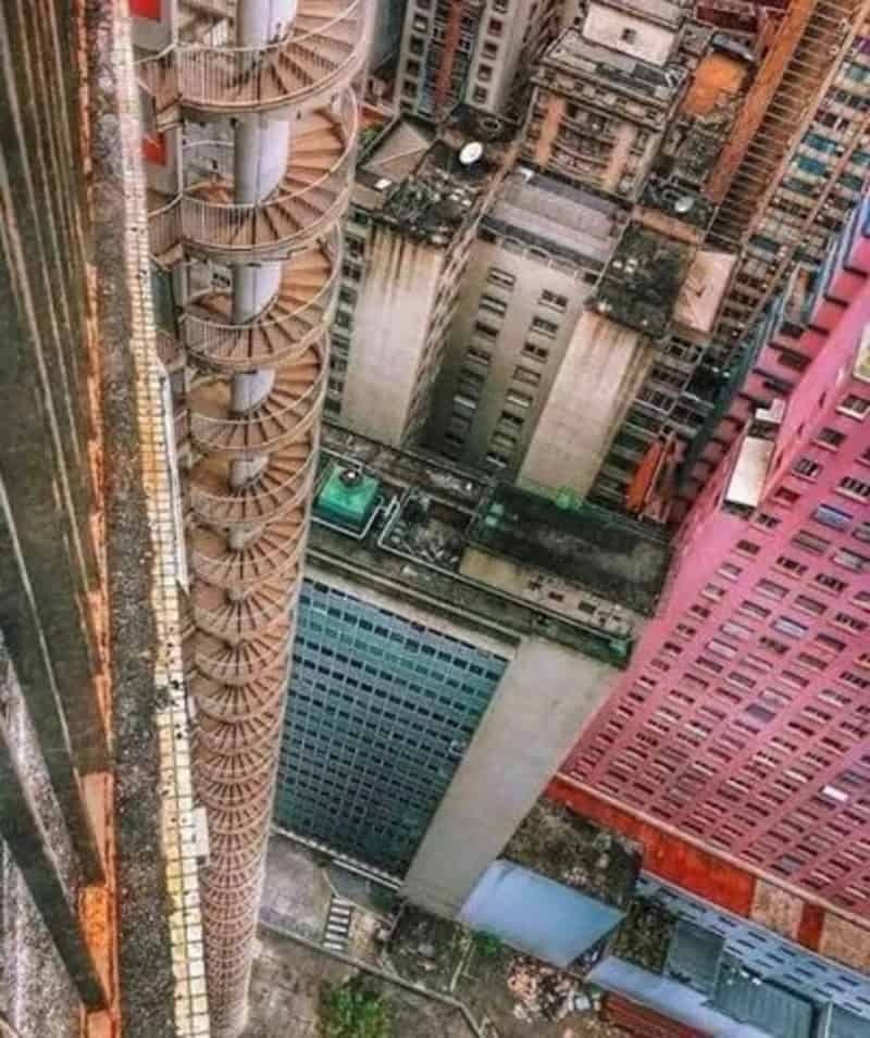 View from a tall building showing surrounding skyscrapers and a rooftop pool.