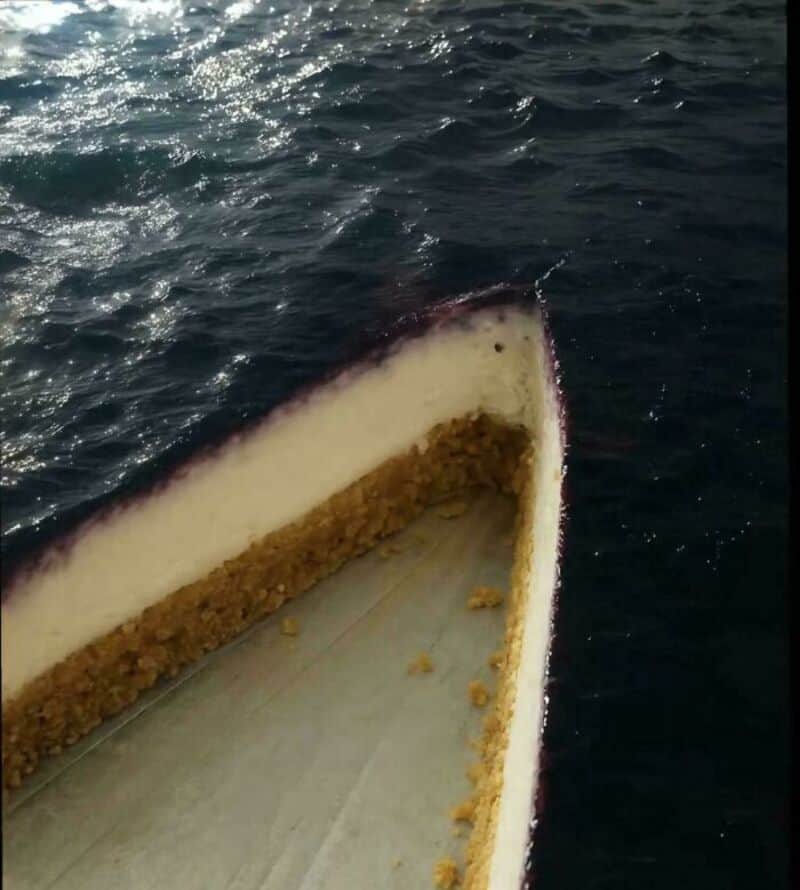 Part of a boat's interior with debris and water, seen from above.