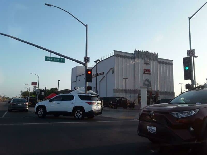 Converted building with a CVS sign on a busy street corner.