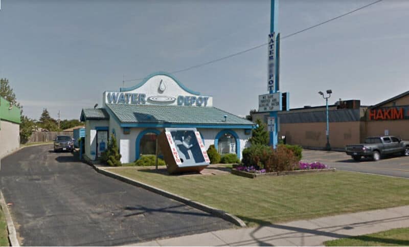 Water Depot building with a large water drop sign and a vending machine outside.