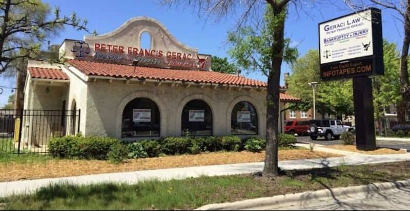 Building with a sign for Peter Francis Geraci and a law office sign outside.