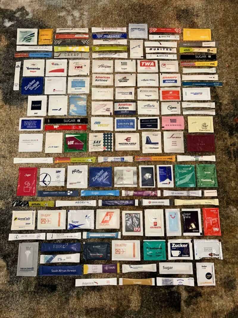 Collection of various cigarette and tobacco product packs arranged on a surface.