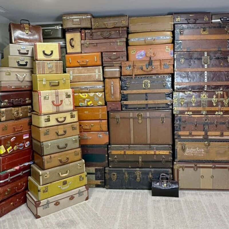 Stacked vintage suitcases in various colors and sizes=