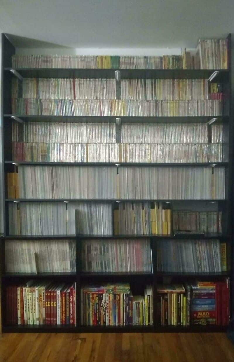 Bookshelves filled with manga and comic books in a room.