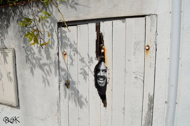 Humorous door repair with a face peeking through a hole in the door.