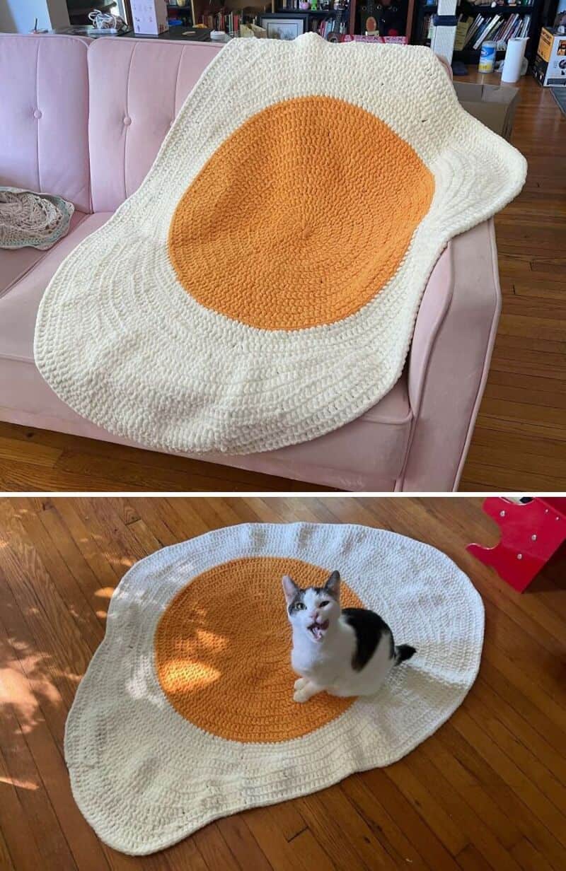 Large crochet rug resembling a fried egg with a white border and yellow center.