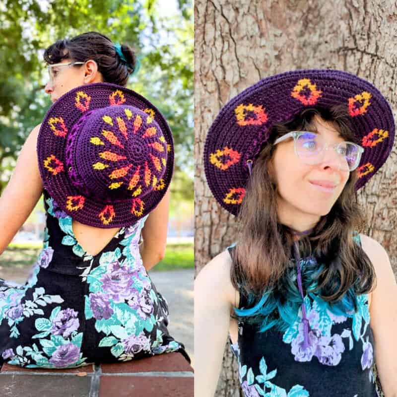 Woman wearing a purple crochet hat with colorful floral patterns, outdoors.