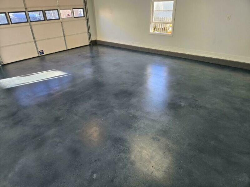 Empty garage with polished concrete floor and white walls.