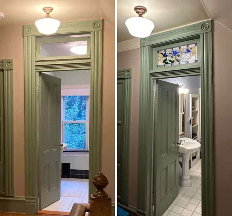Green door with decorative trim leading to a bathroom, with a stained glass window above.