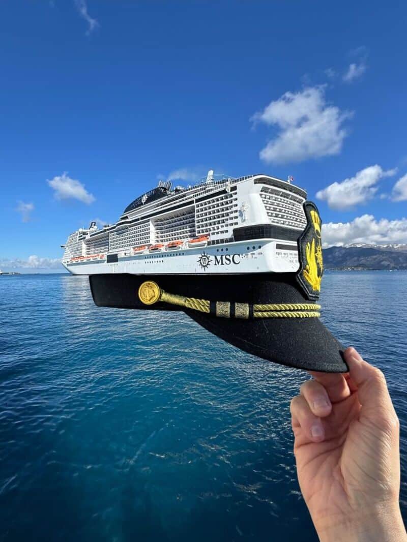 Cruise ship with MSC logo being held with a giant shoe in front.