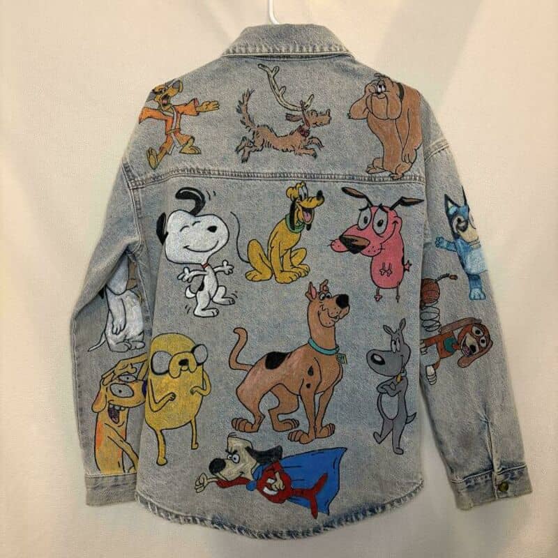 Denim jacket with colorful cartoon dog characters from Scooby-Doo series.