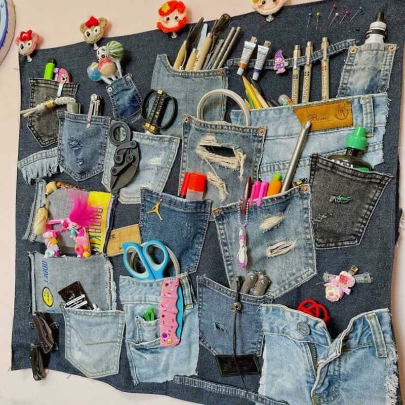 Upcycled denim pocket organizer with craft supplies and toys.