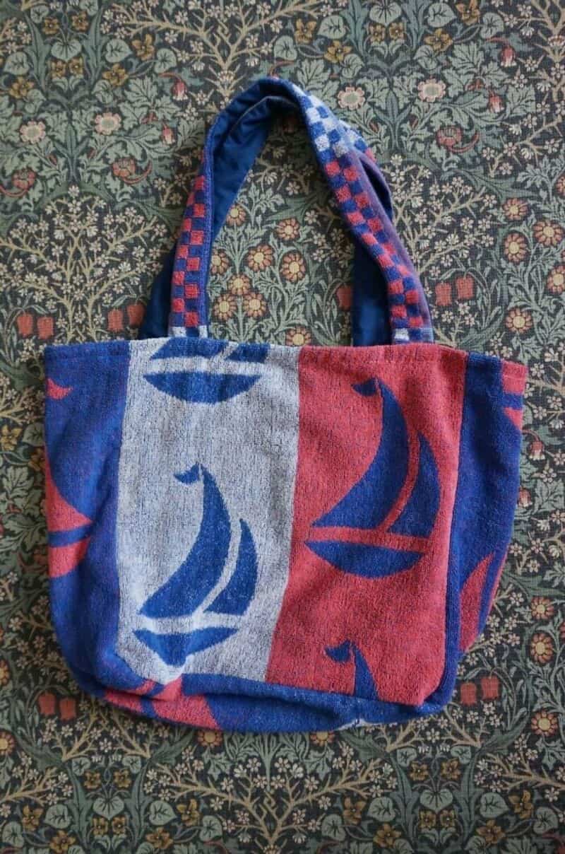 Upcycled tote bag with sailboat pattern in blue, red, and gray colors.