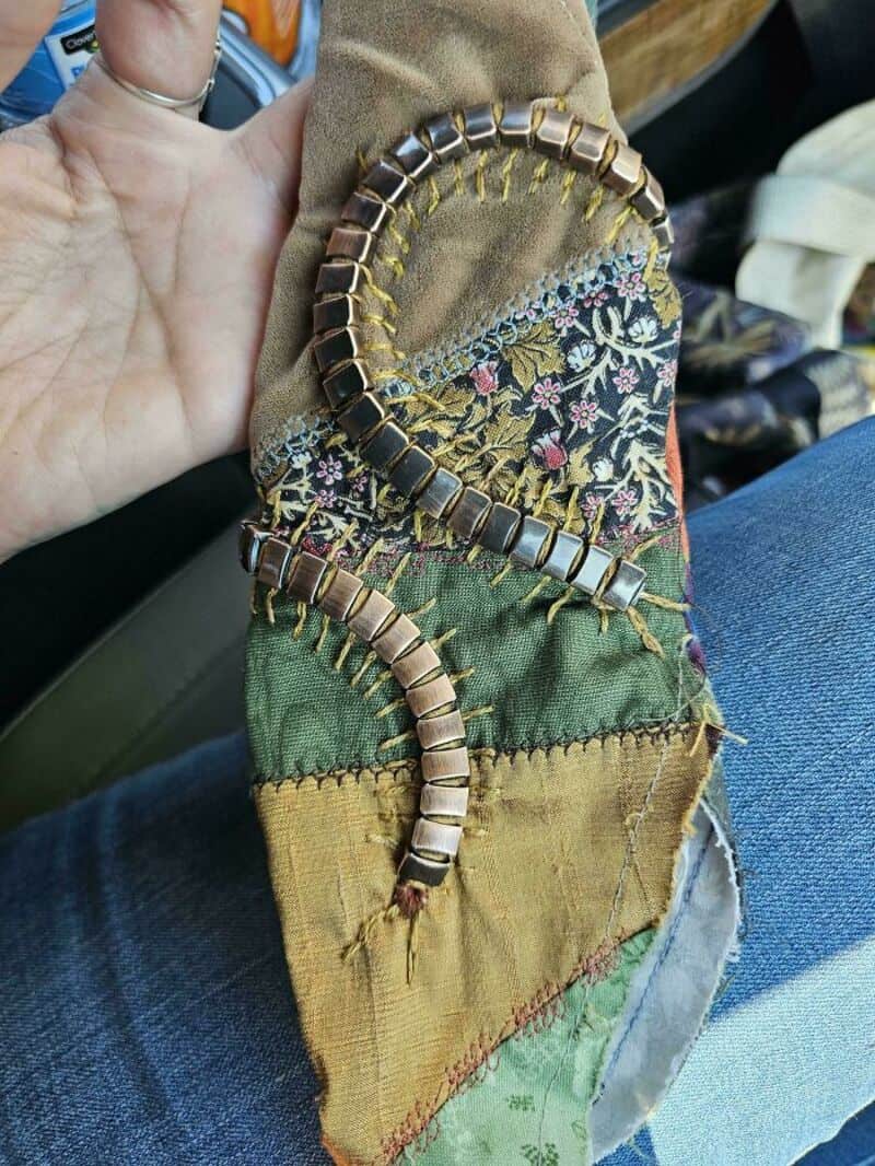 Upcycled fabric with metal and bead embellishments for crafts.
